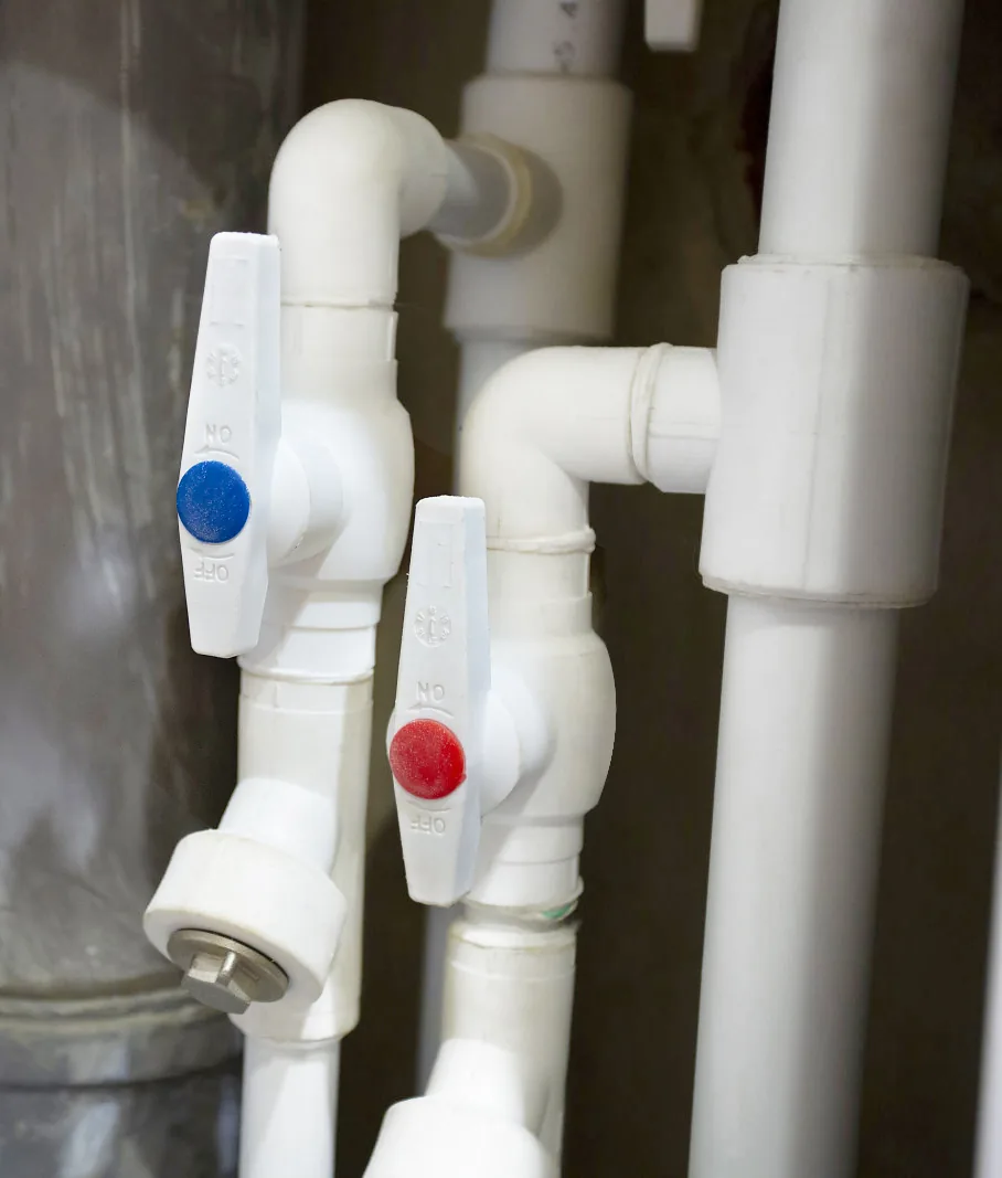 Green PPR valves and pipe run concealed in a wall for hot and cold water