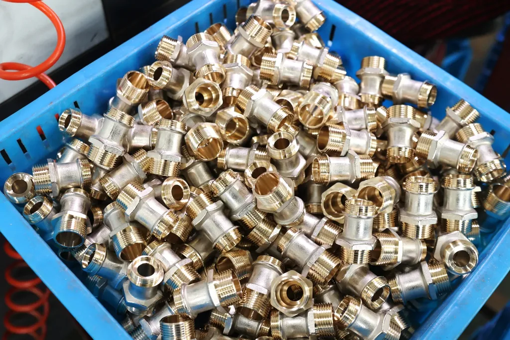 Blue crate filled with knurled brass inserts for PPR fittings